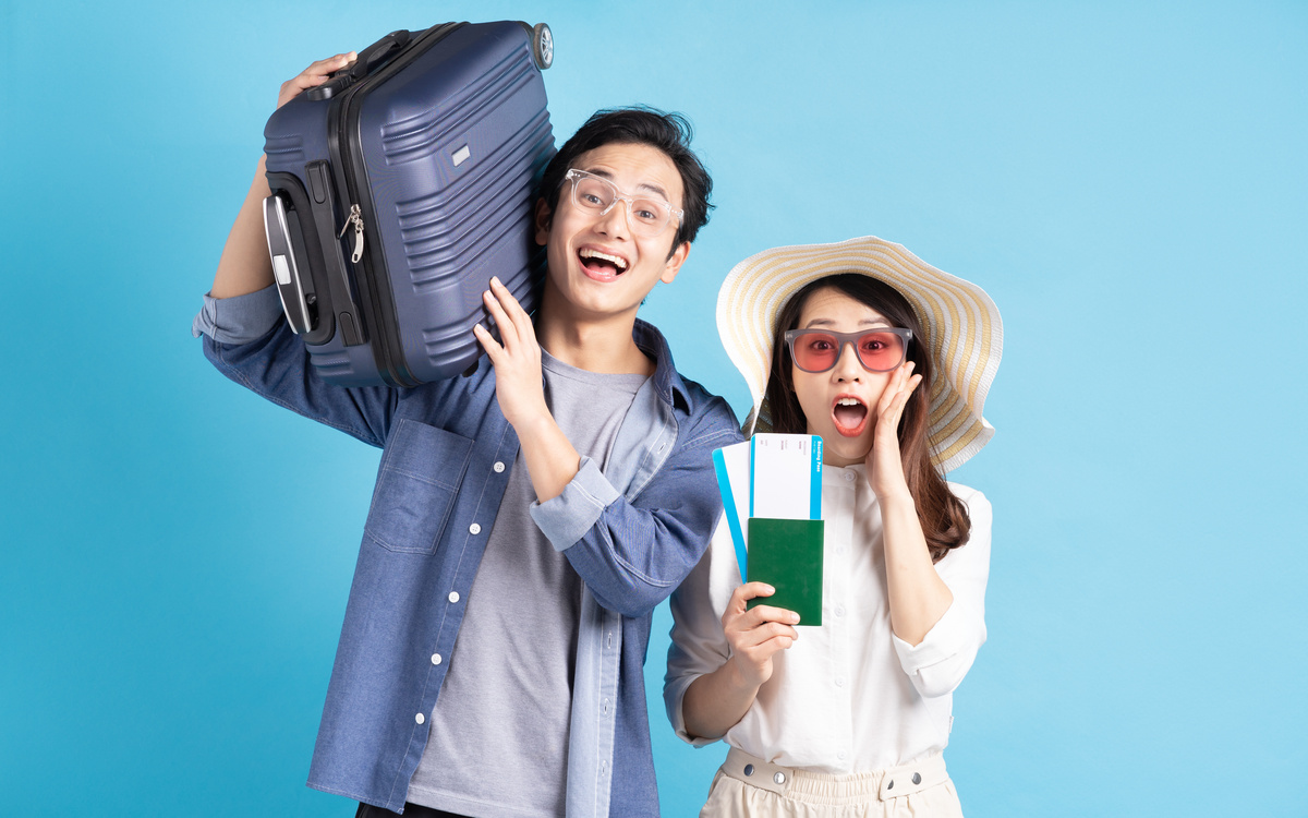 Young Asian Couple Happily Traveling Together